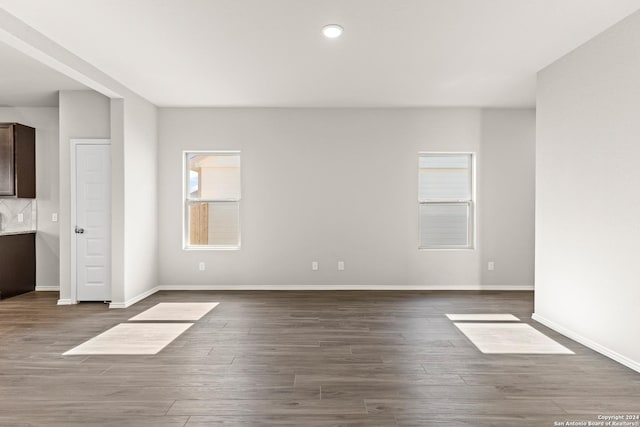 unfurnished room with dark wood-type flooring