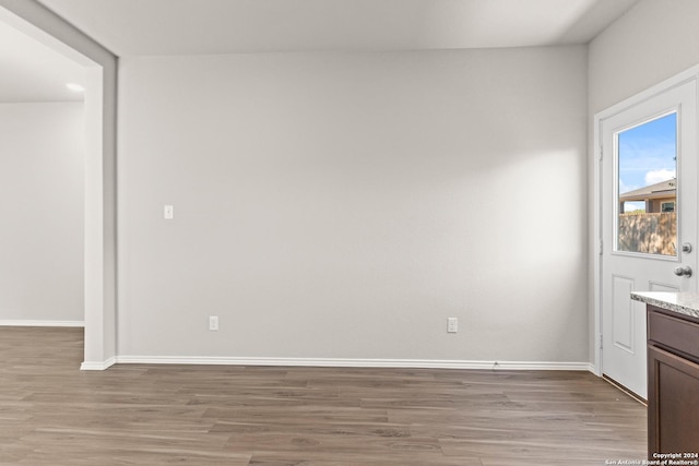 empty room with light hardwood / wood-style flooring