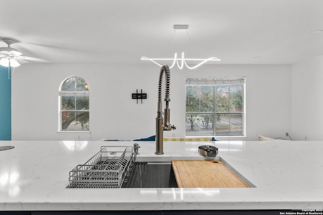 kitchen featuring ceiling fan and a healthy amount of sunlight