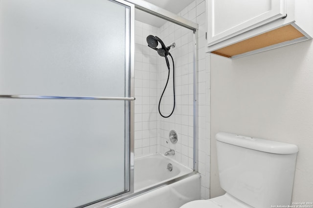 bathroom featuring toilet and enclosed tub / shower combo