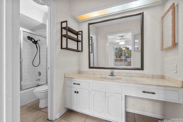 full bathroom featuring vanity, tiled shower / bath, tile patterned flooring, ceiling fan, and toilet