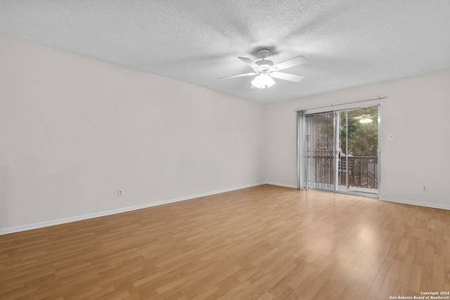 empty room featuring light hardwood / wood-style floors and a textured ceiling