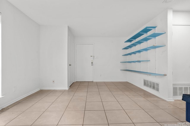 unfurnished room featuring light tile patterned flooring