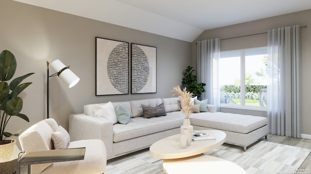 living room with a healthy amount of sunlight, light hardwood / wood-style flooring, and vaulted ceiling