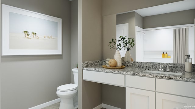 bathroom featuring vanity and toilet