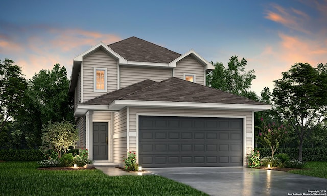 view of front property featuring a garage and a yard