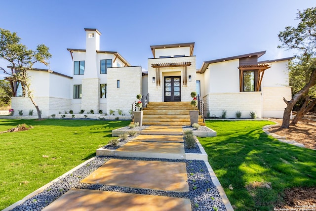 view of front facade featuring french doors and a front lawn