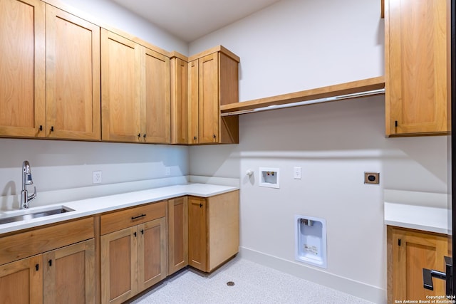 laundry area with washer hookup, hookup for a gas dryer, cabinet space, hookup for an electric dryer, and a sink