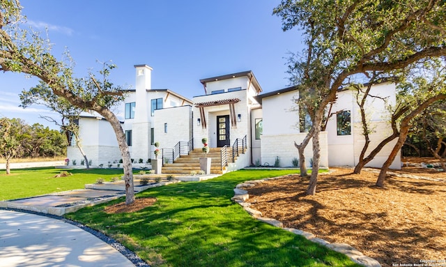 view of front of property with a front yard and stucco siding