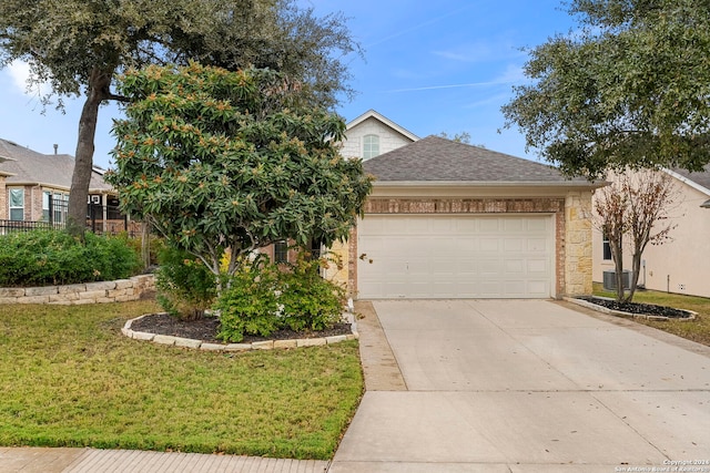 view of front of property featuring a garage, central air condition unit, and a front yard