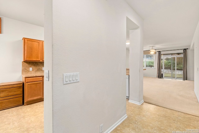 hallway featuring light colored carpet