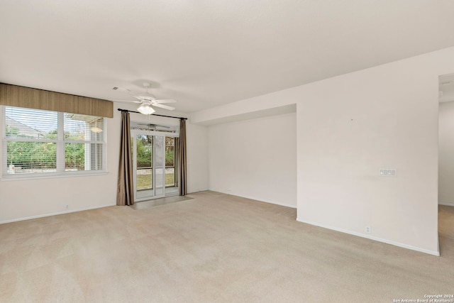 unfurnished room featuring light colored carpet and ceiling fan