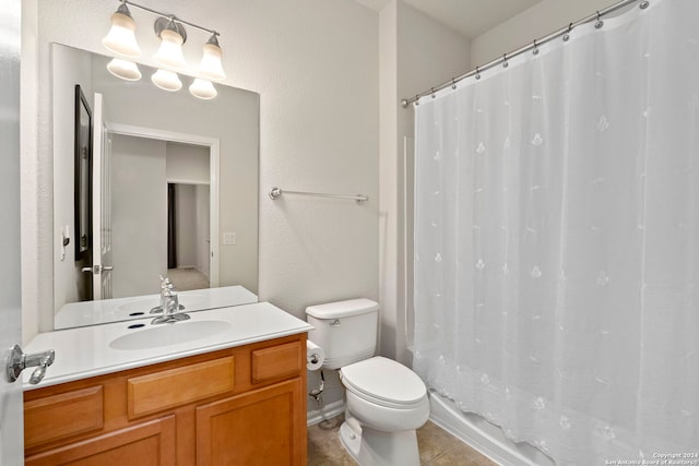 bathroom with tile patterned flooring, vanity, toilet, and walk in shower