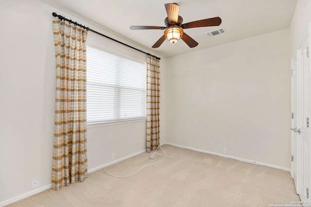 carpeted spare room with ceiling fan