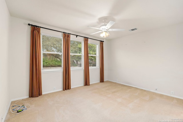 unfurnished room featuring light colored carpet and ceiling fan