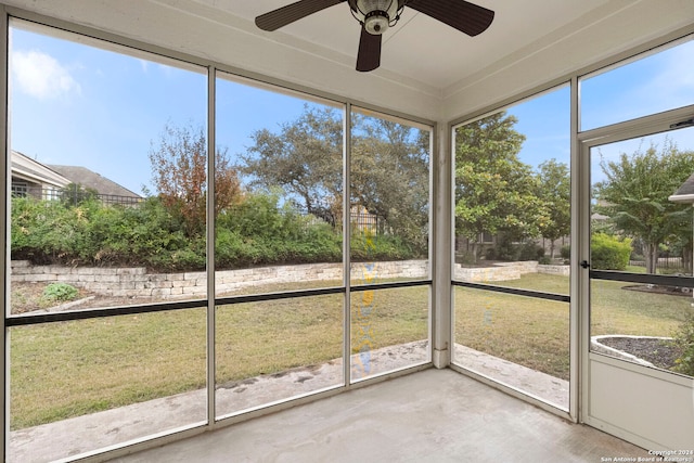 unfurnished sunroom with a wealth of natural light and ceiling fan