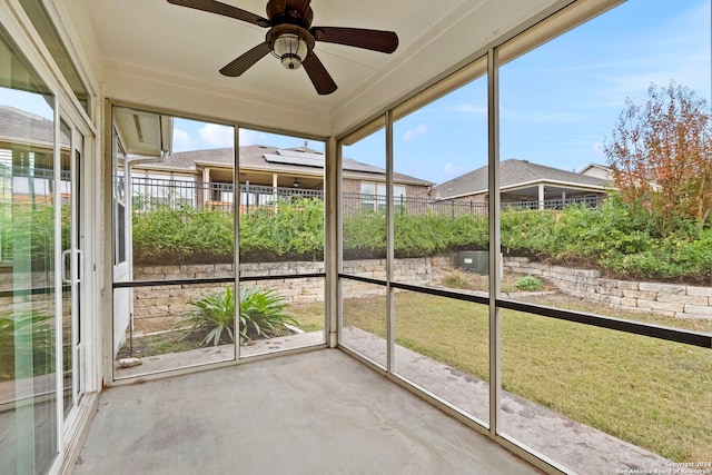 unfurnished sunroom featuring plenty of natural light and ceiling fan