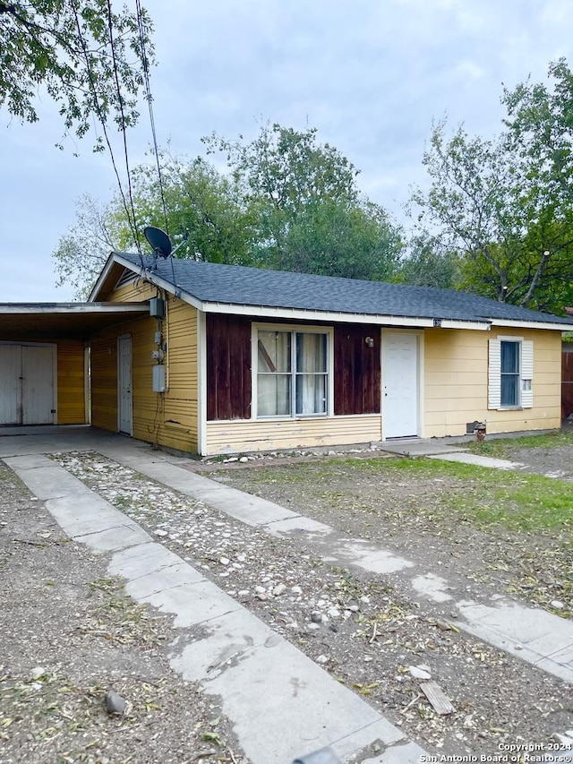 ranch-style house featuring a carport