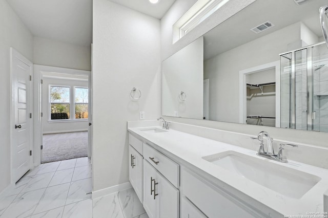 full bathroom with marble finish floor, a sink, visible vents, and a shower stall