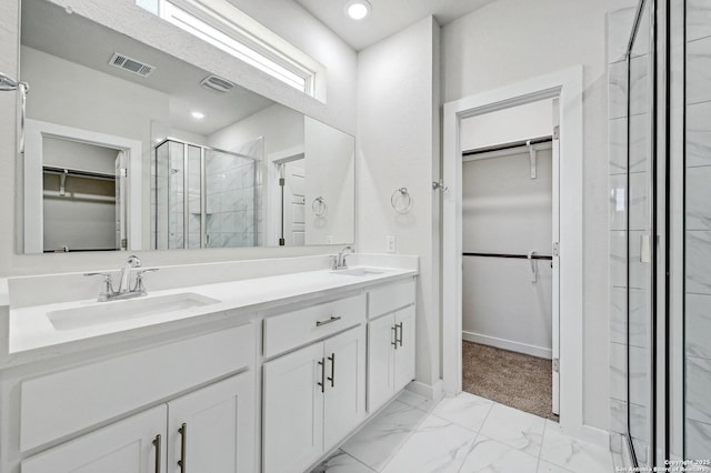 bathroom with marble finish floor, a shower stall, visible vents, and a sink