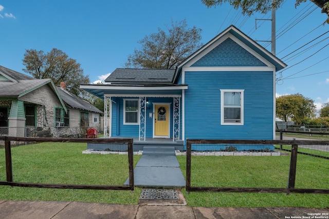 bungalow-style house with covered porch and a front yard