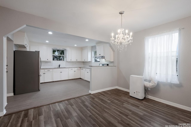 kitchen featuring stainless steel fridge, dark hardwood / wood-style floors, white cabinetry, and tasteful backsplash