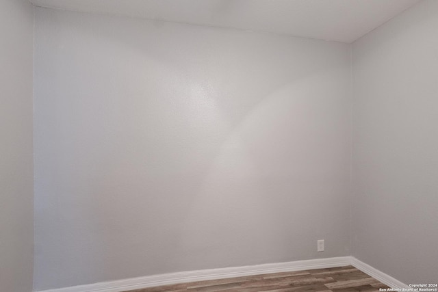 unfurnished room featuring hardwood / wood-style flooring