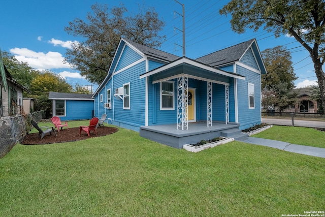 bungalow-style home featuring covered porch and a front lawn