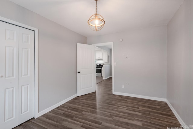 interior space with dark hardwood / wood-style flooring and a closet