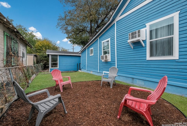 view of yard with cooling unit and a wall mounted AC