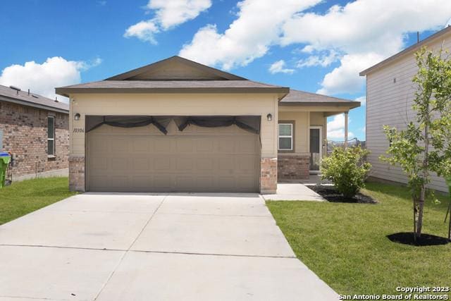 view of front of property with a garage and a front yard