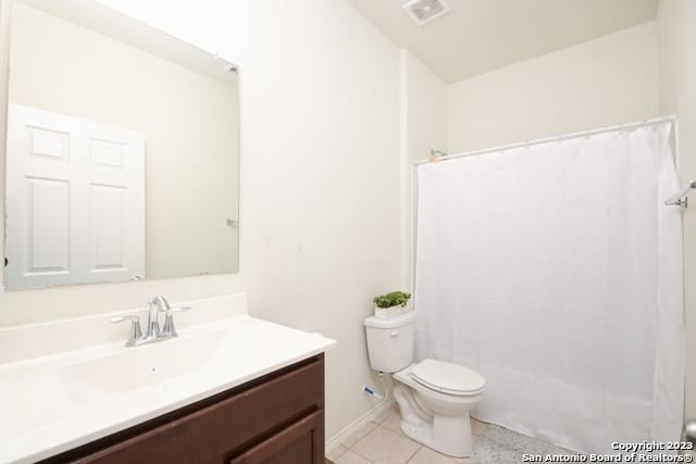 bathroom featuring tile patterned floors, vanity, toilet, and a shower with curtain