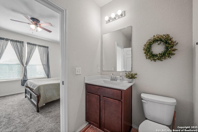 bathroom featuring ceiling fan, vanity, and toilet