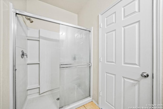 bathroom with walk in shower and tile patterned floors