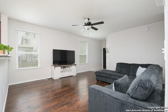 living room featuring dark hardwood / wood-style floors and ceiling fan