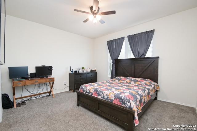 carpeted bedroom with ceiling fan