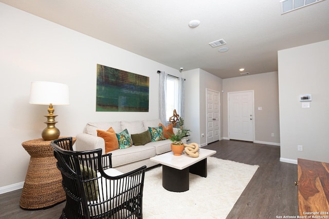 living room with dark hardwood / wood-style flooring