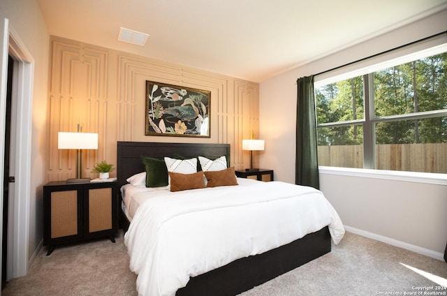 bedroom featuring light colored carpet