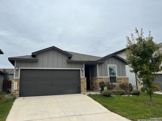 view of front of home with a garage and a front lawn