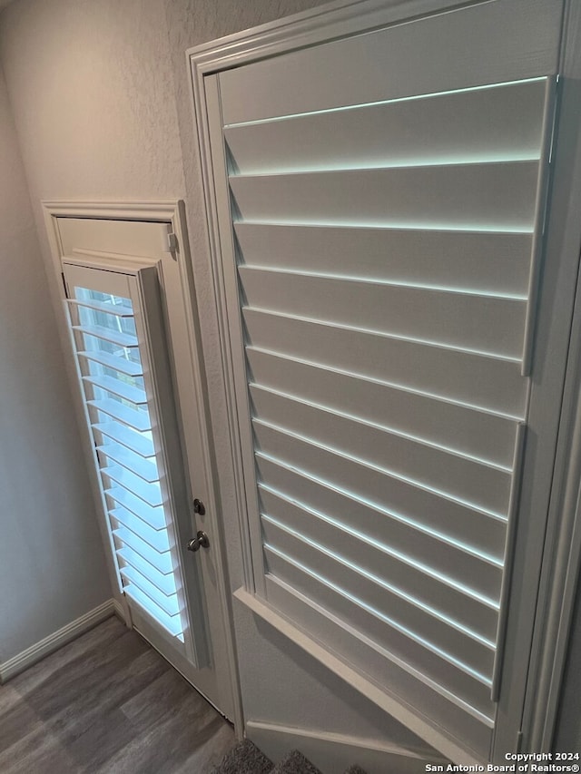 entryway with dark hardwood / wood-style flooring