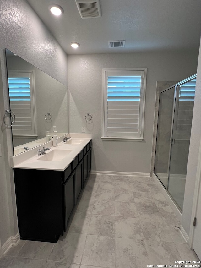 bathroom with vanity and an enclosed shower