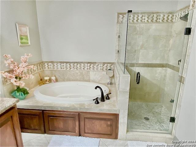 bathroom featuring separate shower and tub, tile patterned floors, and vanity