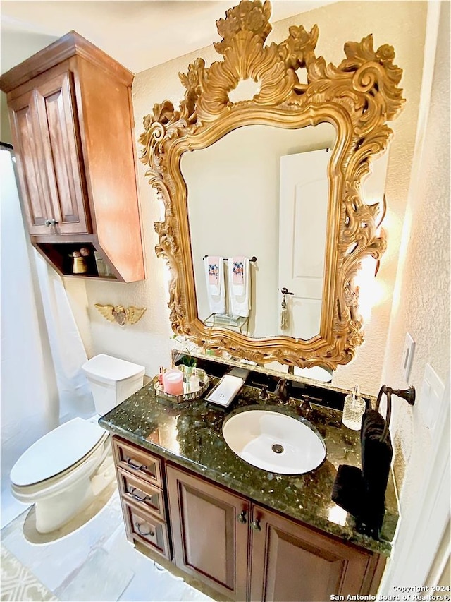 bathroom featuring vanity and toilet