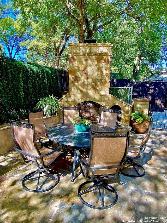 view of patio with an outdoor stone fireplace