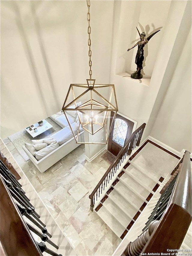 staircase with a chandelier