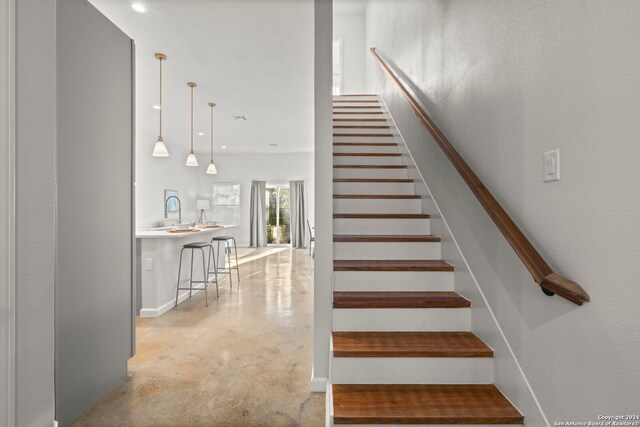 stairs featuring concrete floors