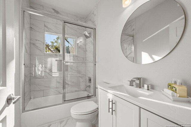 full bathroom with toilet, vanity, and combined bath / shower with glass door