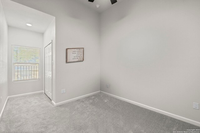 unfurnished room with ceiling fan and light colored carpet