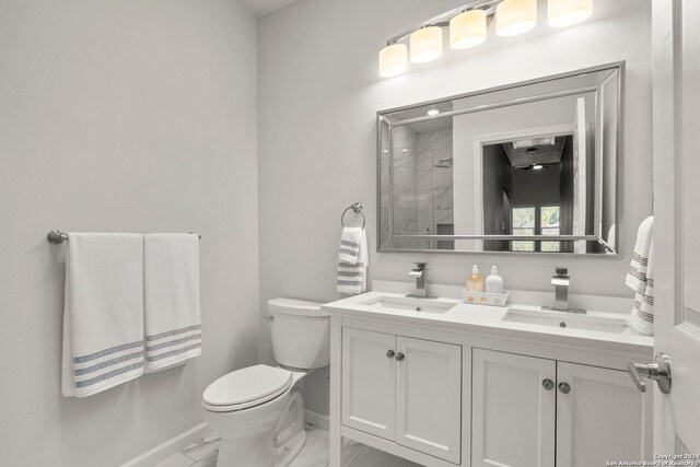 bathroom with walk in shower, vanity, and toilet