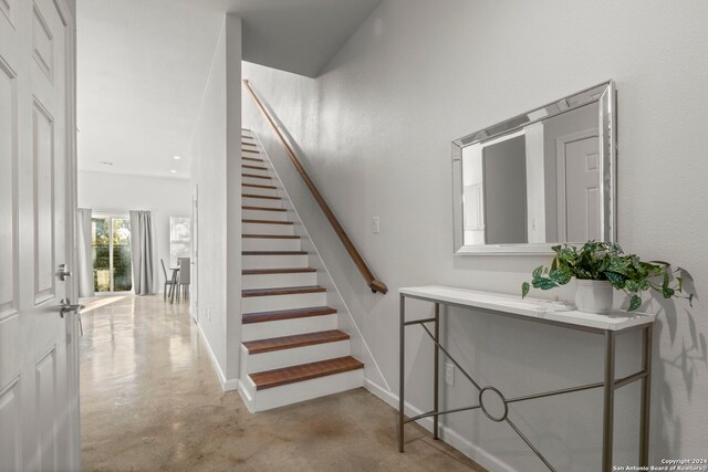 staircase with concrete floors